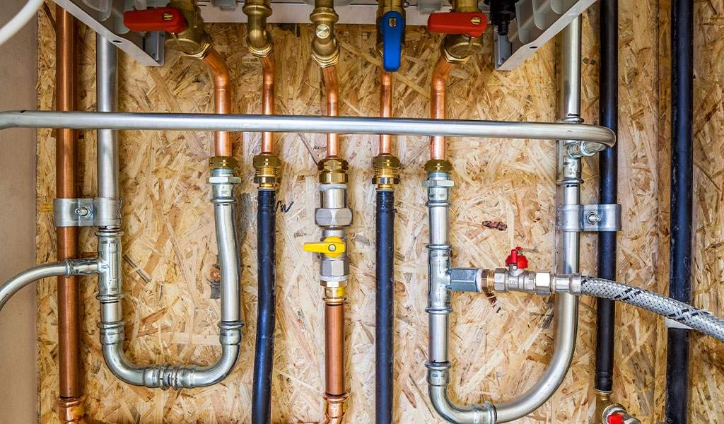 Detailed view of a master plumbing installation featuring a high-quality water distribution manifold and professional shut-off valves