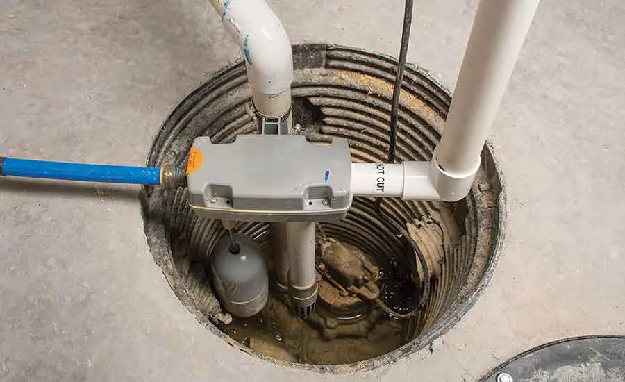 A newly installed high-performance residential sump pump replacement with professional PVC discharge piping