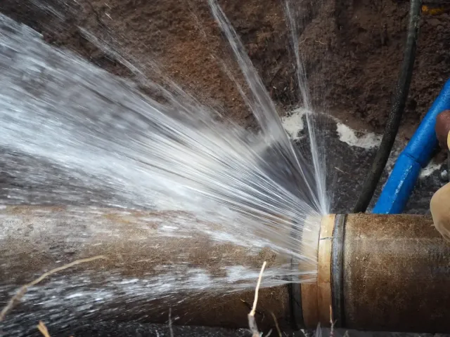 High-pressure main water line burst requiring immediate emergency water line repair and shut-off